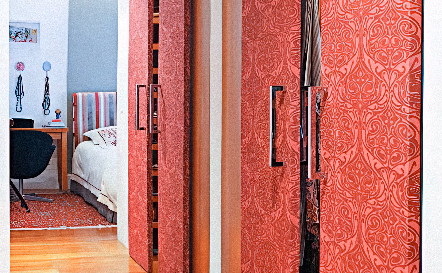 Portes de placard coulissantes habillées de papier peint rouge corail texturé à motifs organiques en relief avec poignées noires graphiques, illustrant une transformation DIY réversible qui ajoute du caractère luxueux sans modification structurelle permanente. Portes de placard coulissantes habillées de papier peint rouge corail texturé à motifs organiques en relief avec poignées noires graphiques, illustrant une transformation DIY réversible qui ajoute du caractère luxueux sans modification structurelle permanente.