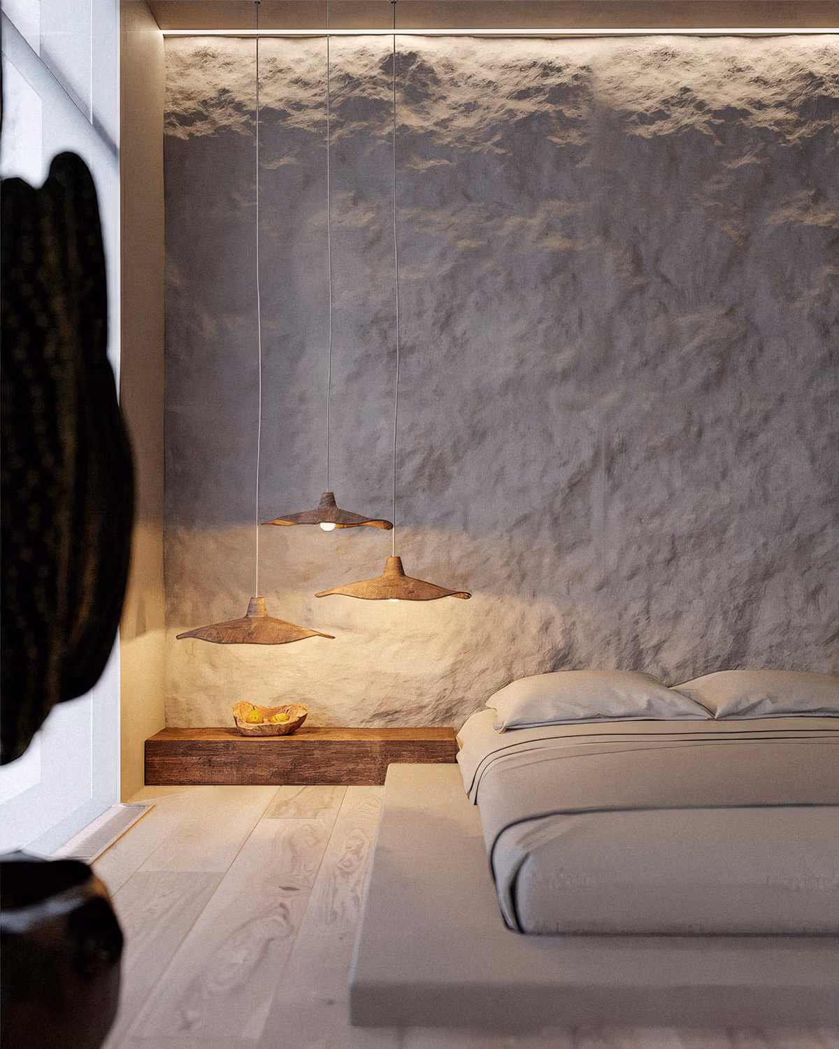 Chambre Japandi épurée avec mur en enduit texturé gris éclairé par bandeau LED indirect, lit bas style futon en lin beige, table de chevet flottante en poutre de bois brut massif, trio de suspensions organiques en forme de feuilles patinées et parquet chêne blanchi créant une atmosphère wabi-sabi contemplative